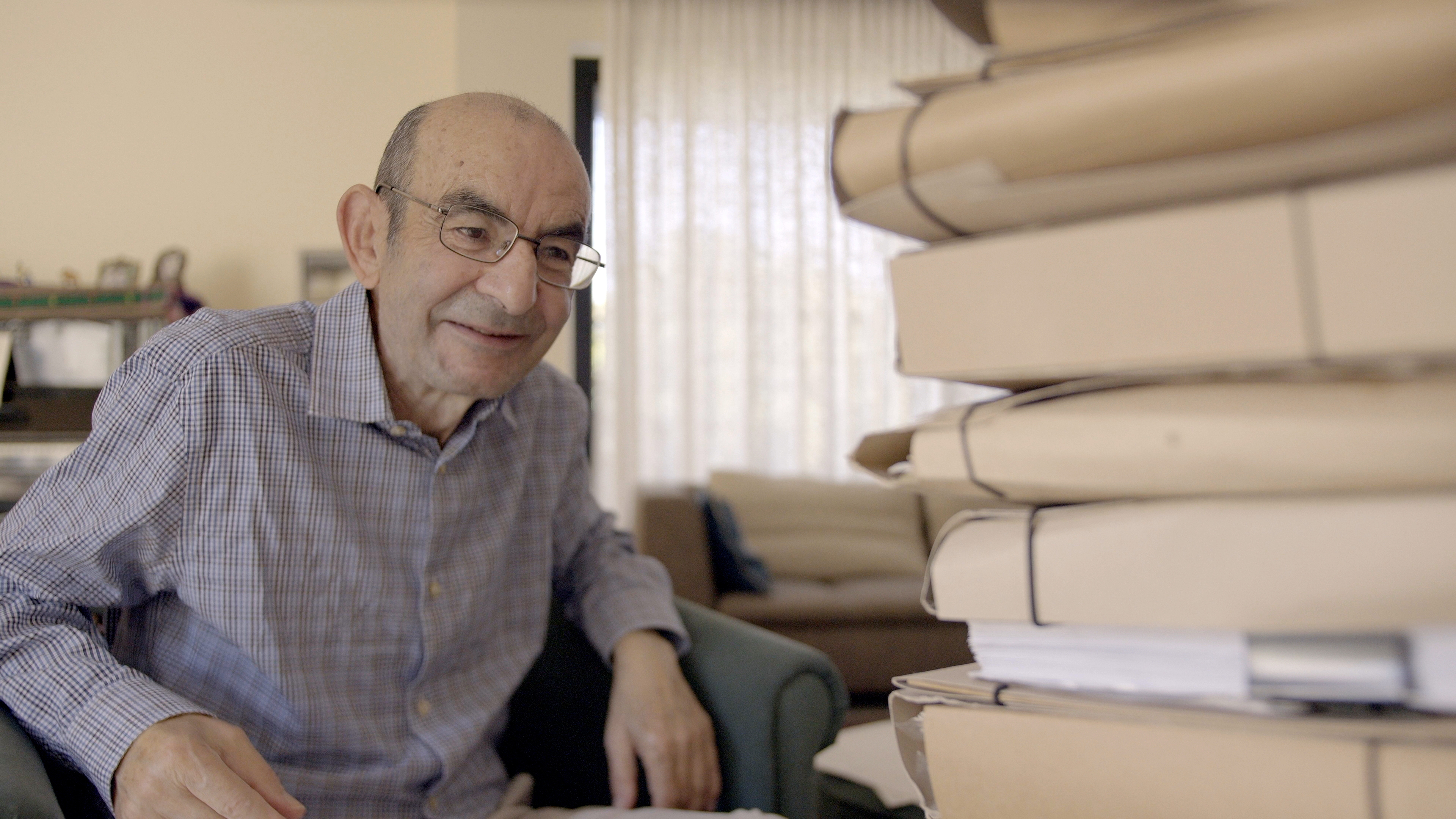 Raja Shehadeh looks at folders from his archive in 2026.
